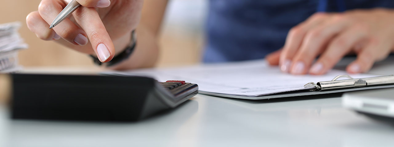 Man Doing Math on Calculator