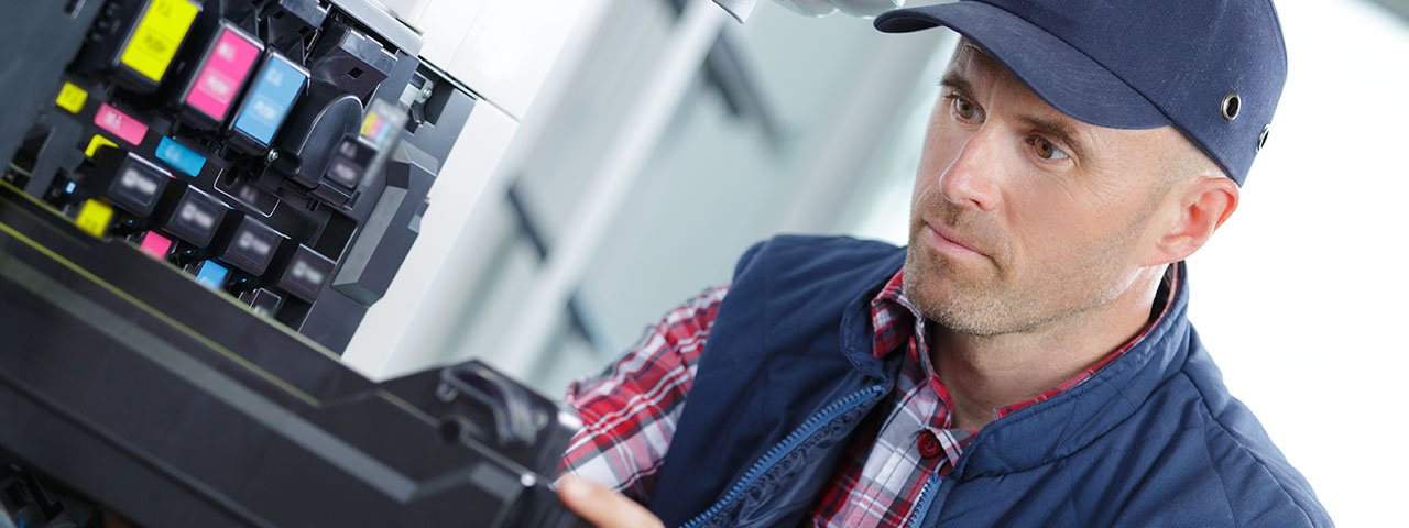 Man Fixing Printer Man Fixing Printer